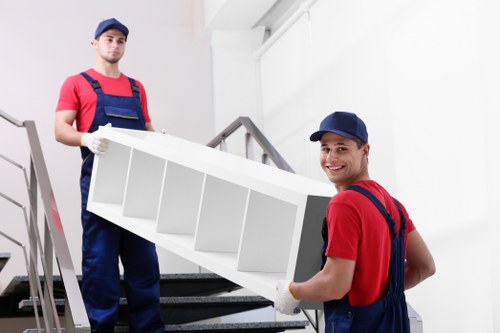 Movers preparing a residential move in Wanstead with boxes and furniture