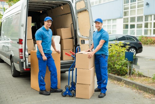 Removal team handling furniture with care during loading