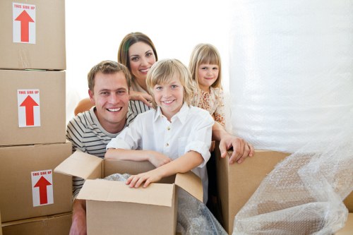 Professional movers carrying boxes and furniture during a Wanstead move